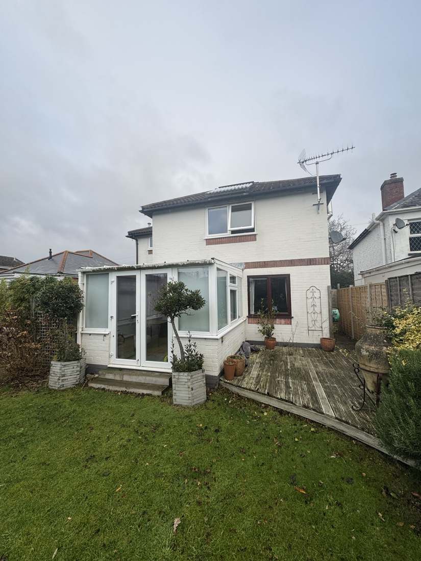 Before: old uPVC conservatory and decking at the back of the house