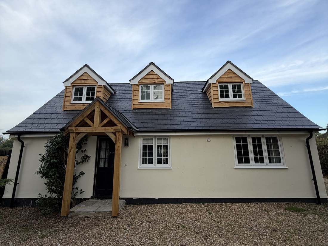 After: new slate roof, timber-clad dormers and oak porch