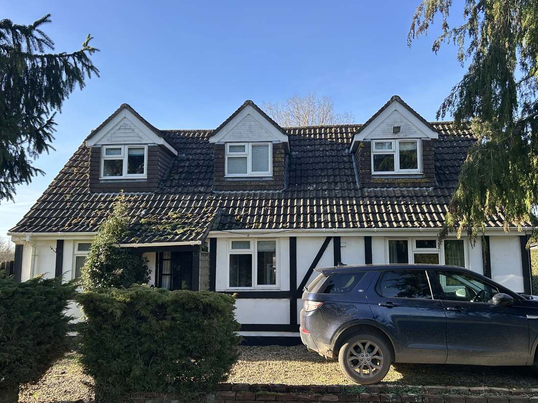 Before: tired concrete tile roof with mossy tiles and old dormers
