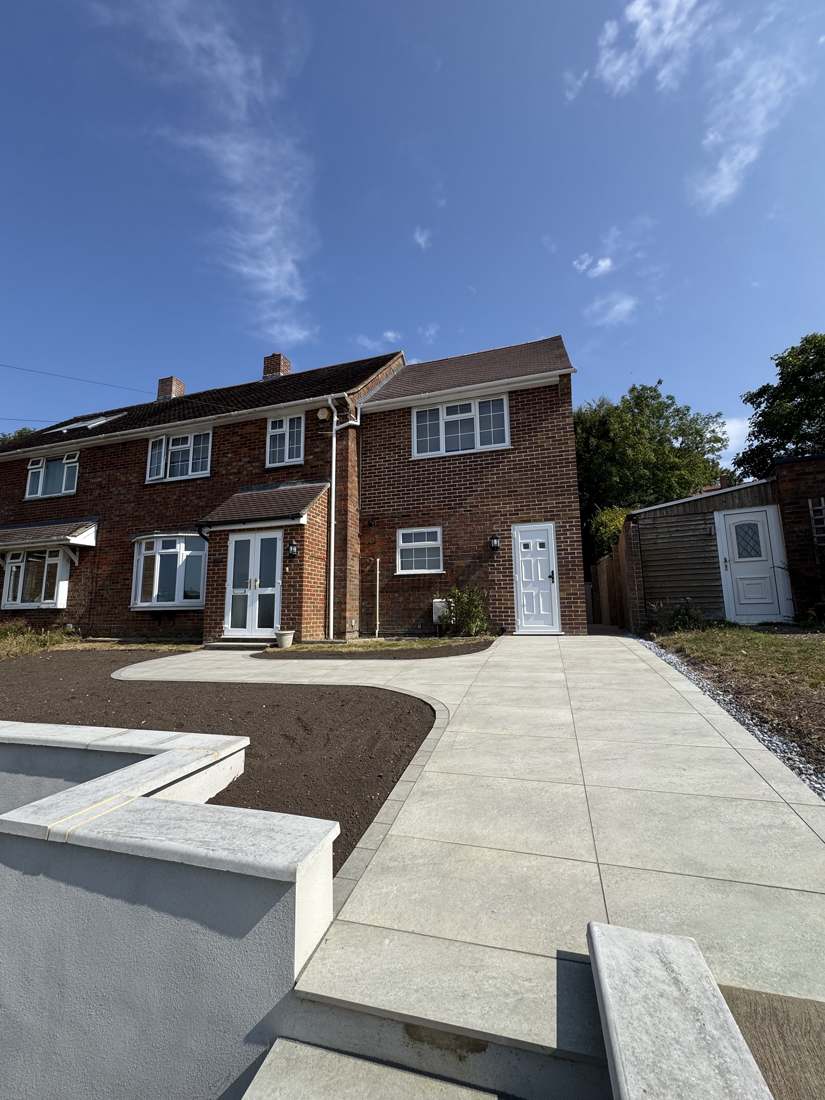 After: new two-storey side extension, porcelain driveway and rendered retaining walls